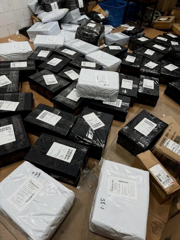 Daily outbound shipments — labelled packages bound for international destinations via DHL and EMS
